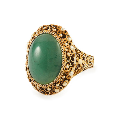 Beautiful green quartzite cabochon gemstone in an intricate filigree silver-gilt setting. Adjustable shank.