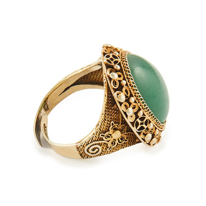 Beautiful green quartzite cabochon gemstone in an intricate filigree silver-gilt setting. Adjustable shank.