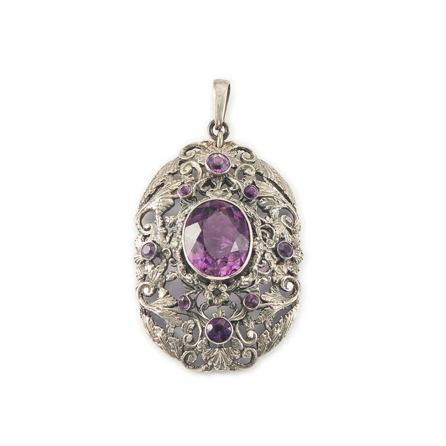 Regal silver pendant set with a large, beautifully faceted purple amethyst stone, surrounded by  eight small amethysts in an intricate design.