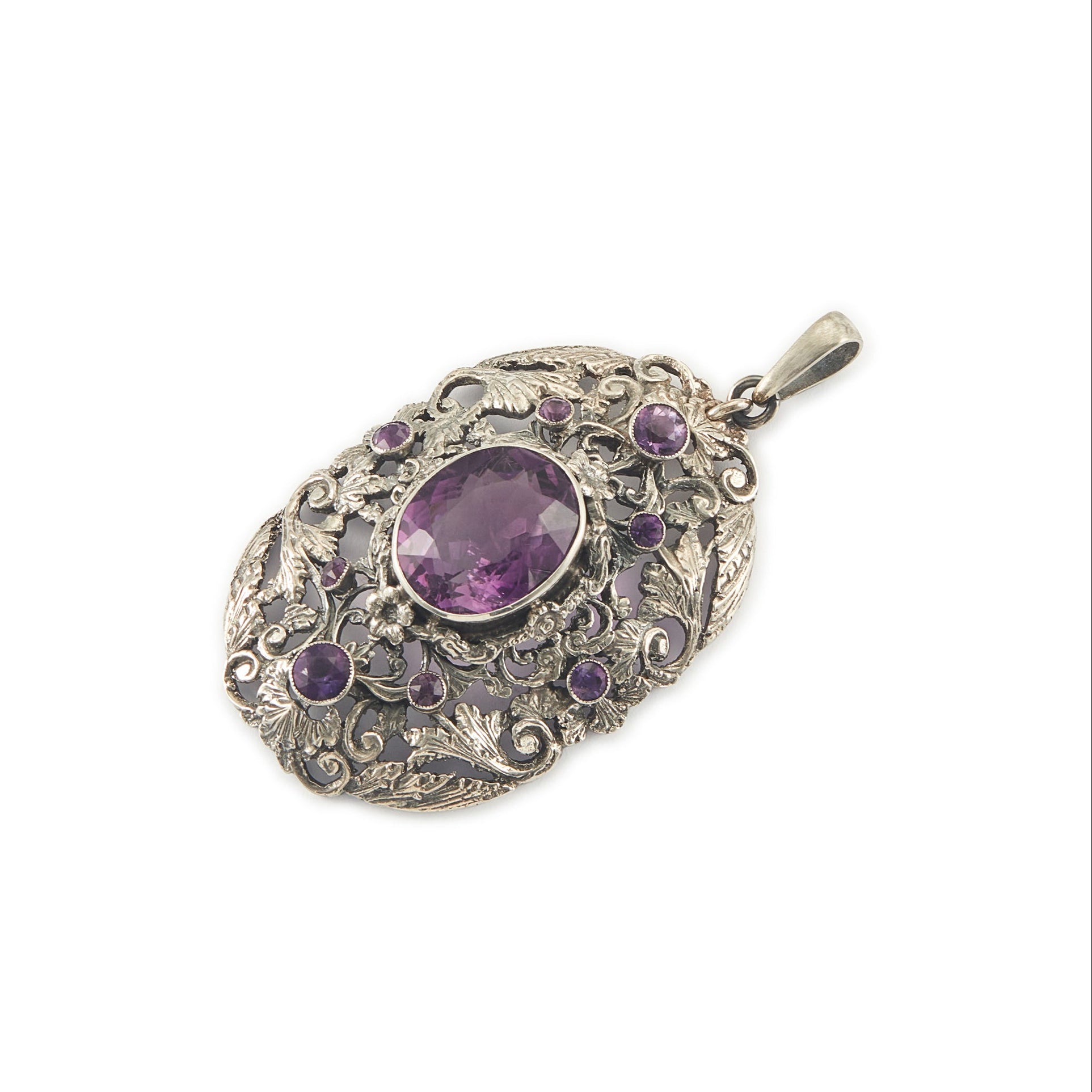 Regal silver pendant set with a large, beautifully faceted purple amethyst stone, surrounded by  eight small amethysts in an intricate design.