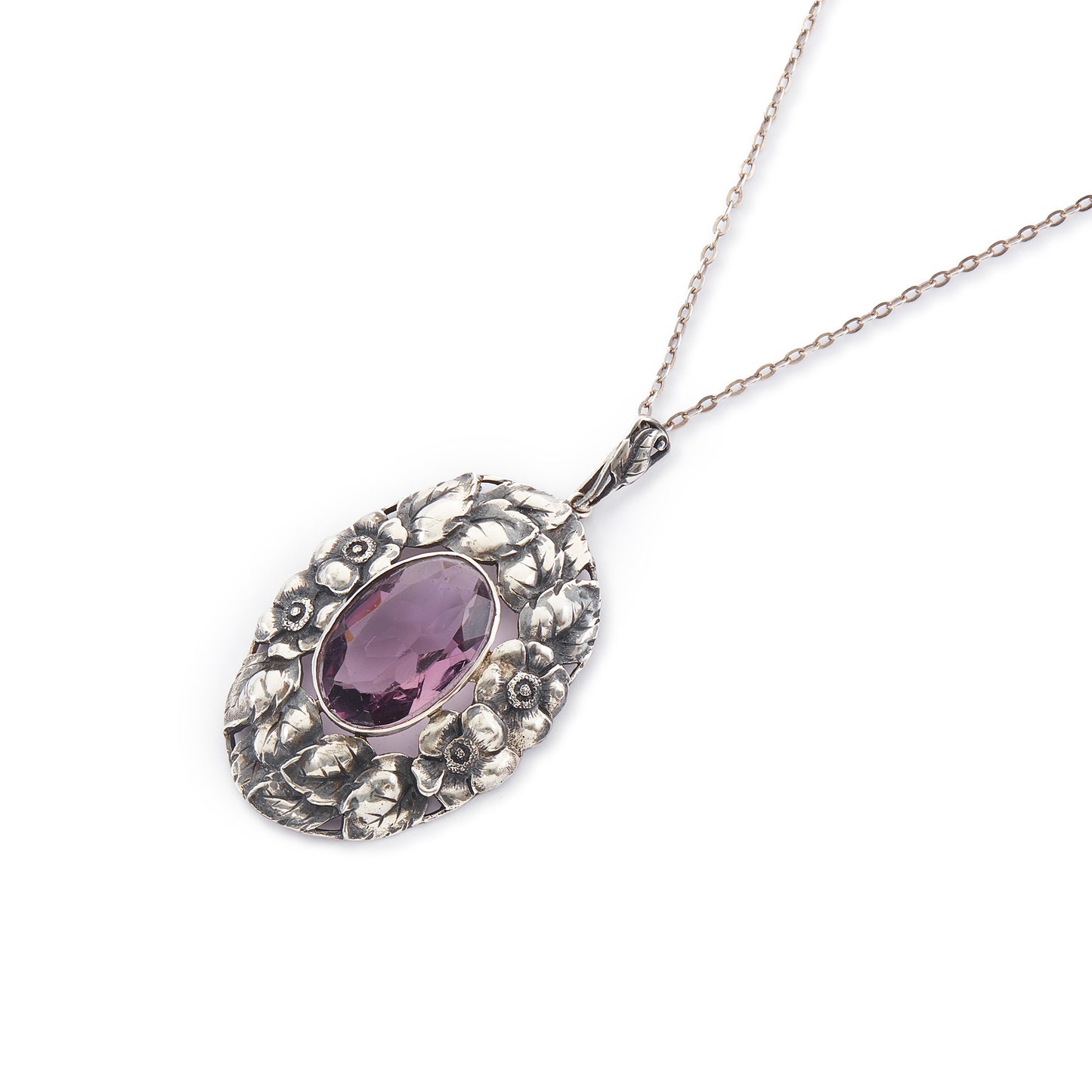 Very ornate oval pendant with a beautifully faceted purple amethyst in a floral setting, on a silver chain. 800 Silver. German
