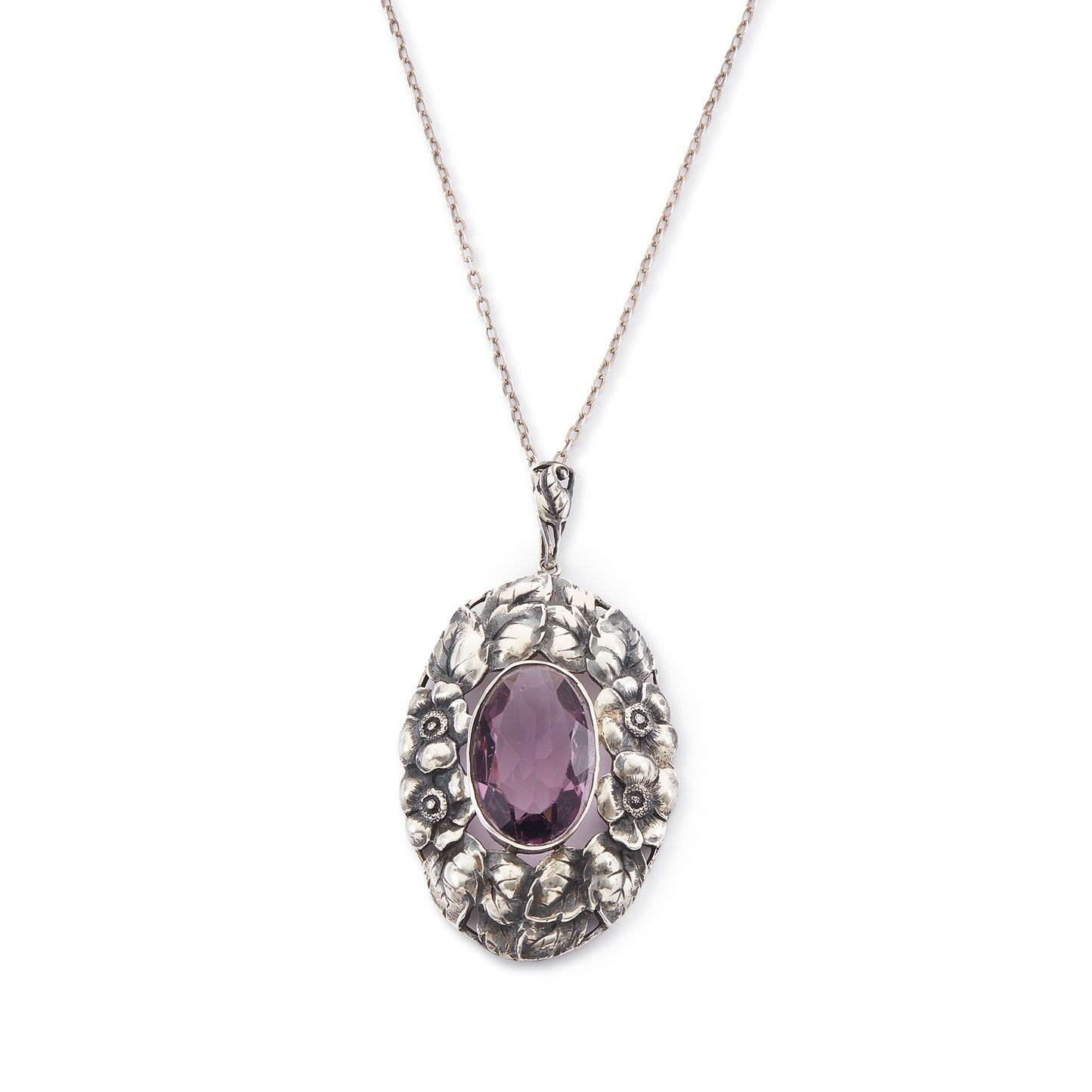 Very ornate oval pendant with a beautifully faceted purple amethyst in a floral setting, on a silver chain. 800 Silver. German
