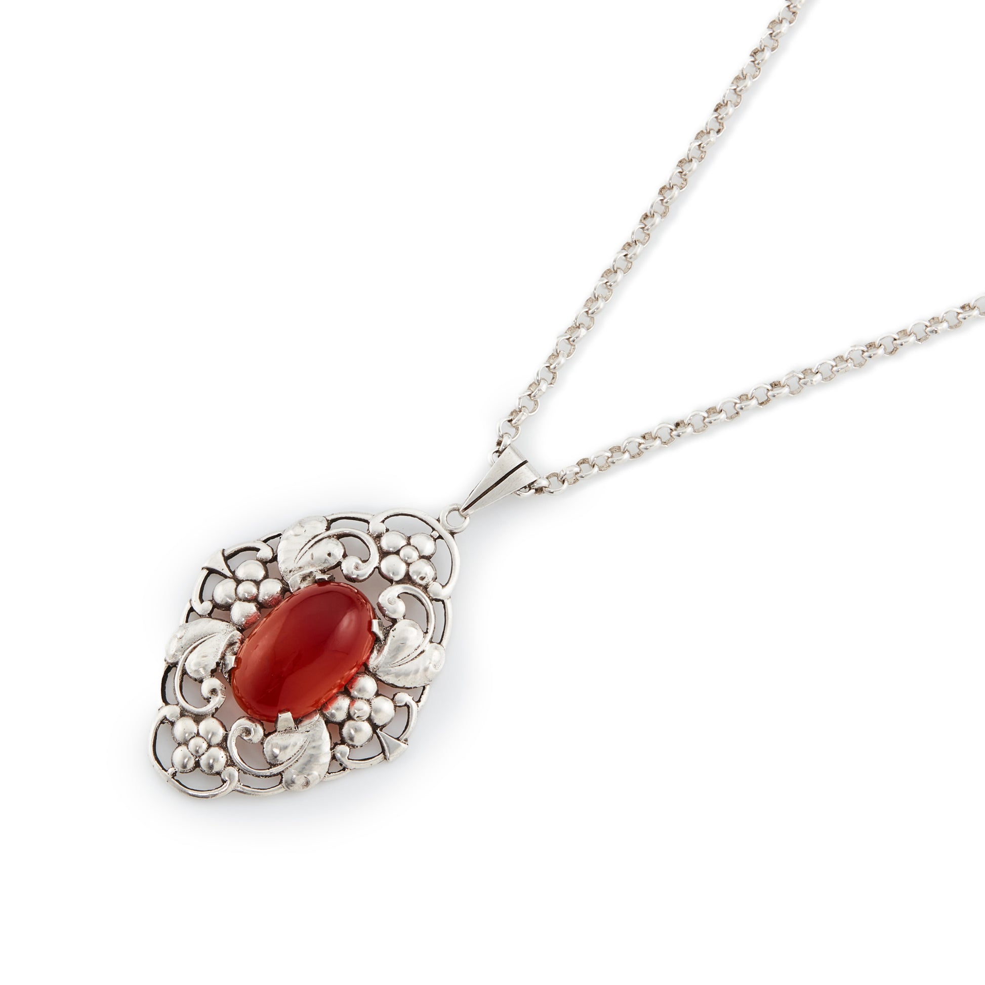 Lovely silver Arts and Crafts pendant set with an oval cabochon carnelian, on a vintage silver chain. Circa 1910