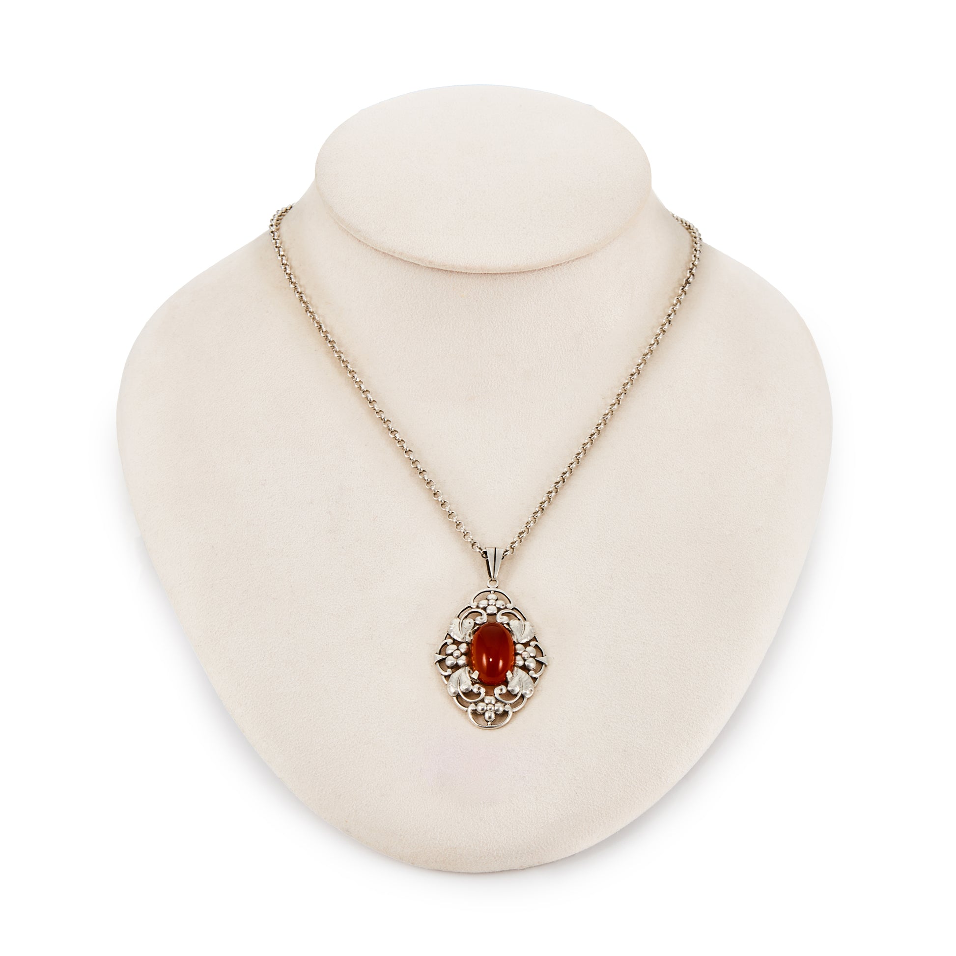 Lovely silver Arts and Crafts pendant set with an oval cabochon carnelian, on a vintage silver chain. Circa 1910