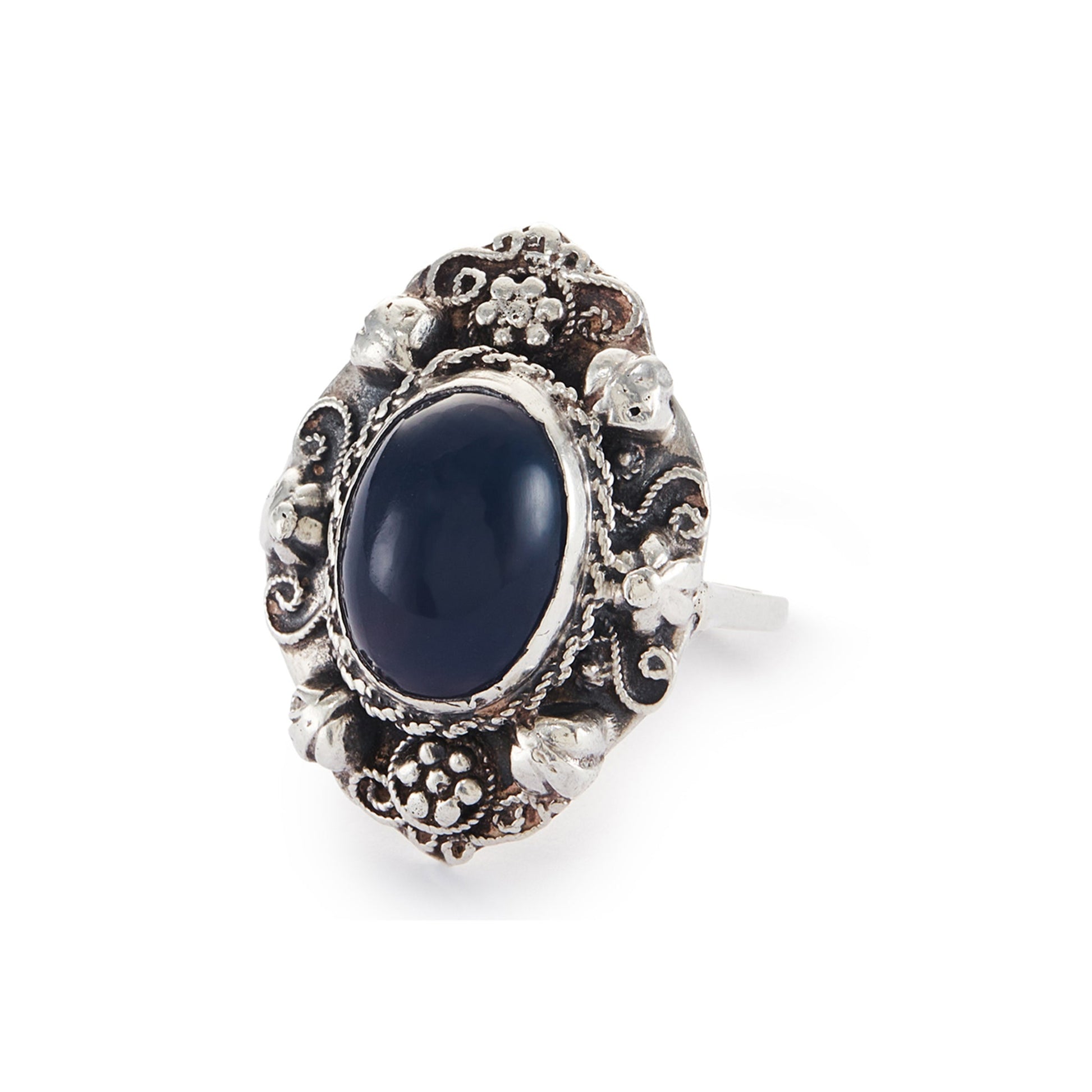 Lovely silver Arts and Crafts ring set with a cabochon sodalite, surrounded by intricate floral detail.