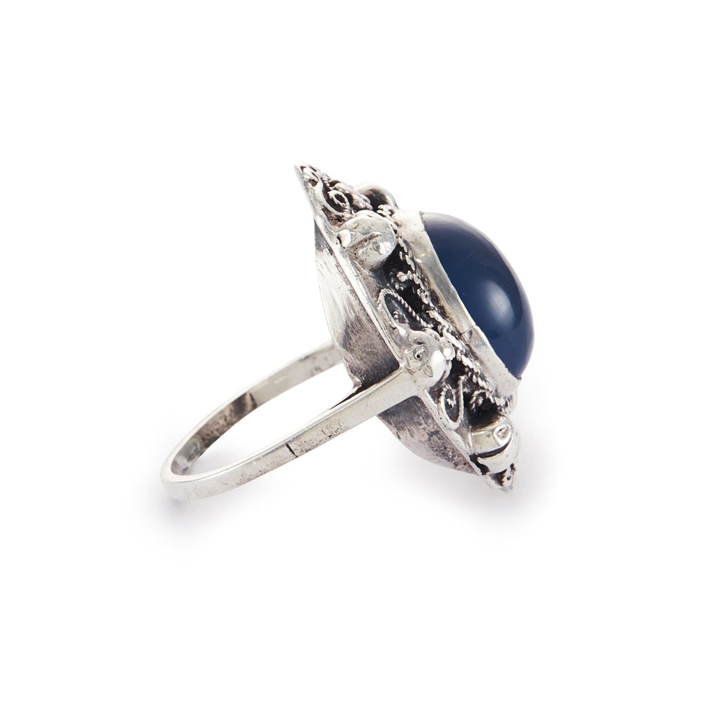 Lovely silver Arts and Crafts ring set with a cabochon sodalite, surrounded by intricate floral detail.