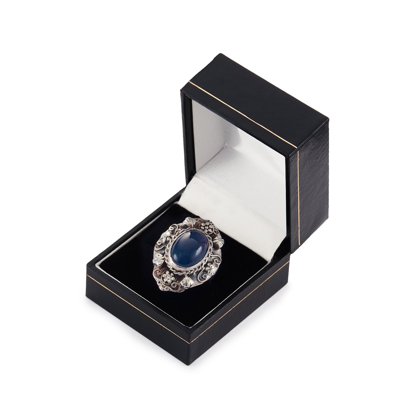 Lovely silver Arts and Crafts ring set with a cabochon sodalite, surrounded by intricate floral detail.