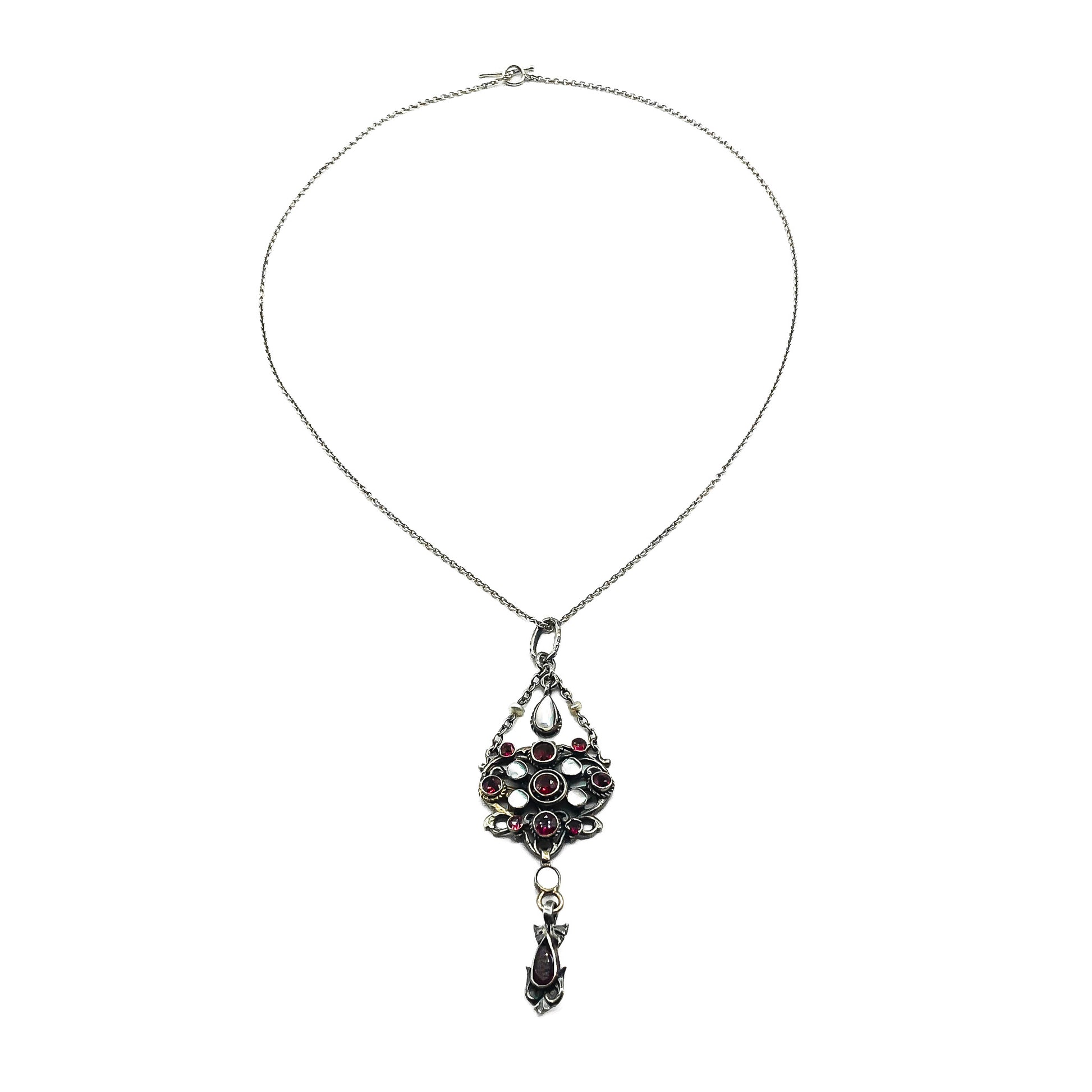 Intricate silver Austro-Hungarian garnet and pearl pendant with dangling drops, on a silver chain.   Circa 1910