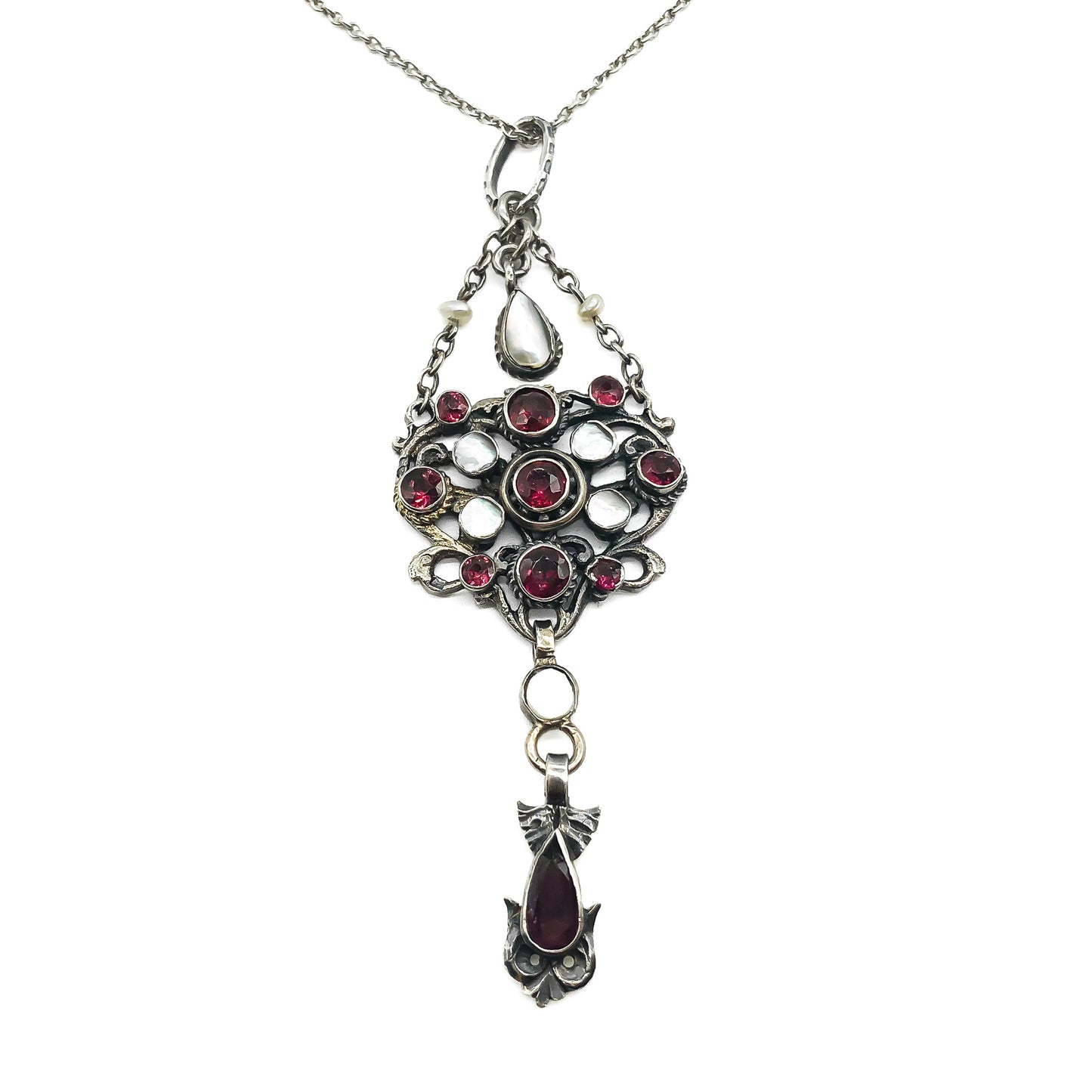 Intricate silver Austro-Hungarian garnet and pearl pendant with dangling drops, on a silver chain.   Circa 1910