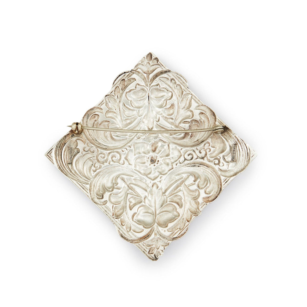 Impressive Mid-Century sterling silver Candida brooch with an intricate repoussé floral design.