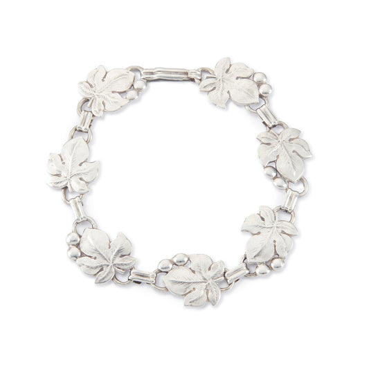 Classic silver Candida bracelet (unmarked) with seven linked grape vine leaves.