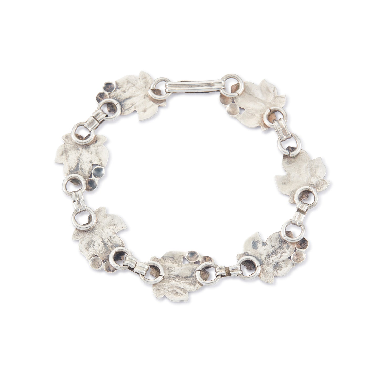 Classic silver Candida bracelet (unmarked) with seven linked grape vine leaves.