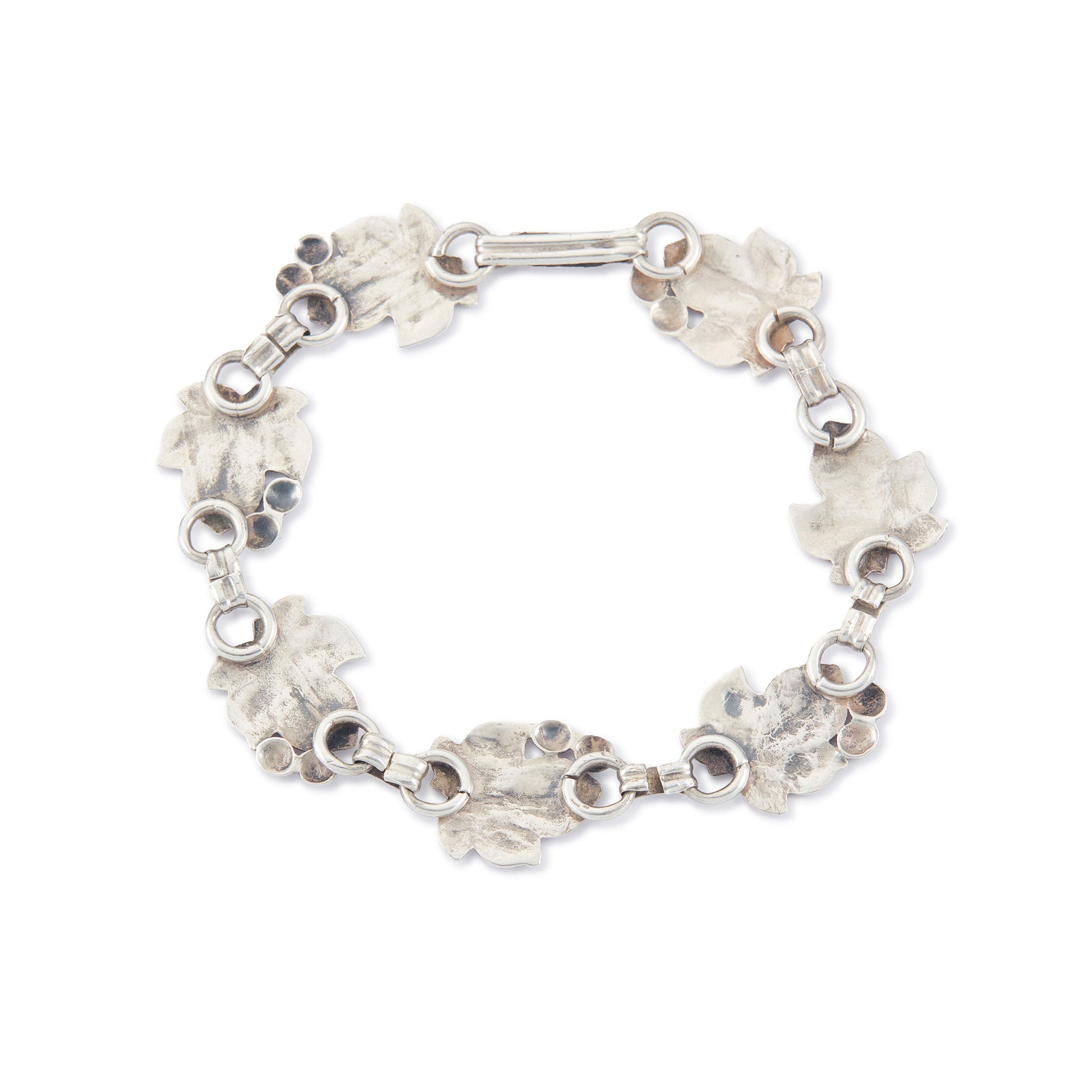 Classic silver Candida bracelet (unmarked) with seven linked grape vine leaves.