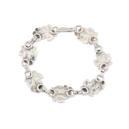 Classic silver Candida bracelet (unmarked) with seven linked grape vine leaves.