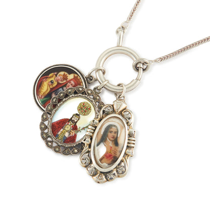 Vintage silver chain with three stunning antique religious silver pendants hanging from a large silver bolt ring clasp, one porcelain, one enamelled in a marcasite setting and one hand-painted, in an elaborate silver setting.