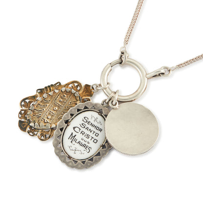 Vintage silver chain with three stunning antique religious silver pendants hanging from a large silver bolt ring clasp, one porcelain, one enamelled in a marcasite setting and one hand-painted, in an elaborate silver setting.