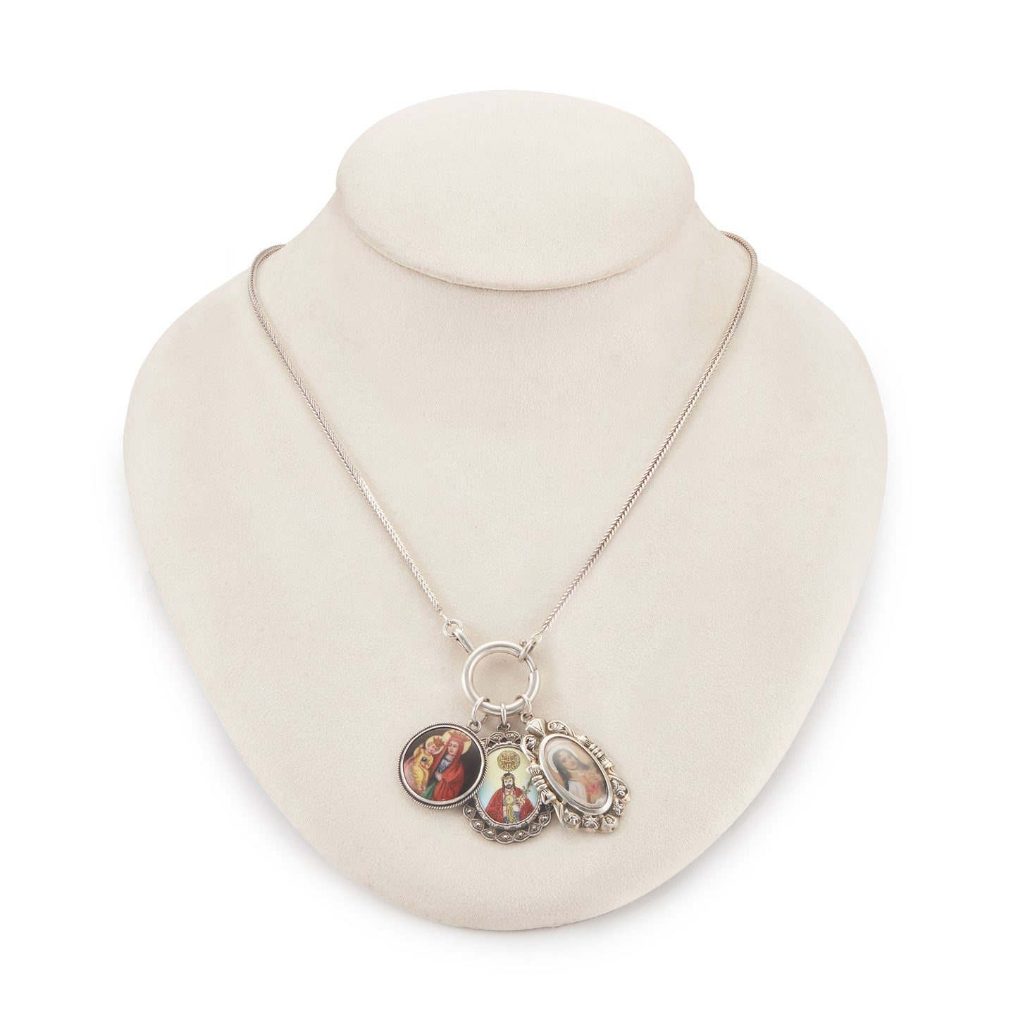 Vintage silver chain with three stunning antique religious silver pendants hanging from a large silver bolt ring clasp, one porcelain, one enamelled in a marcasite setting and one hand-painted, in an elaborate silver setting.