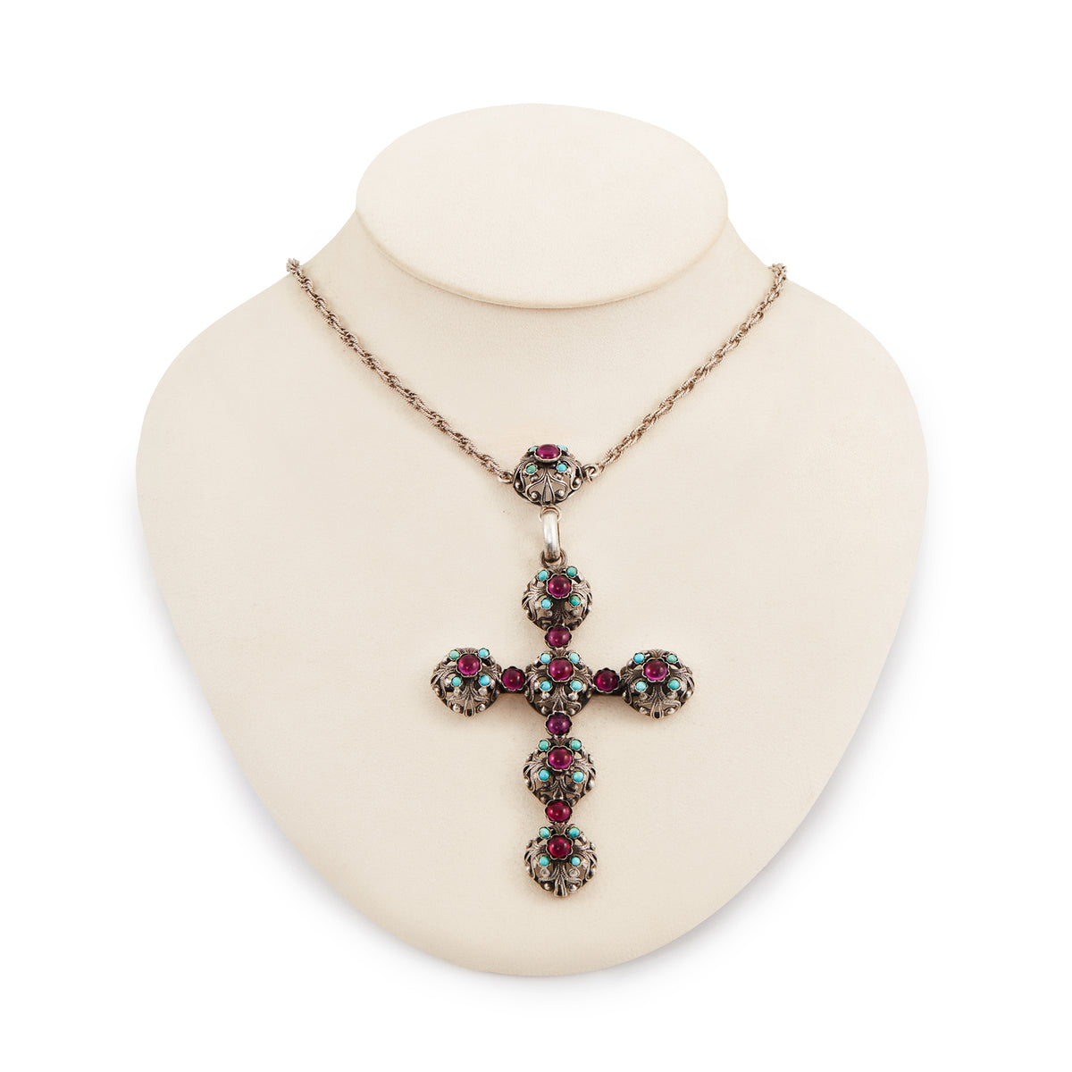 Spectacular large Edwardian cross pendant set with sixteen cabochon turquoise stones and eleven vibrant purple glass stones, on a silver rope chain.