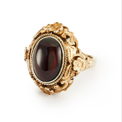Exquisite Austro-Hungarian silver gilt ring with a beautiful cabochon garnet in an ornate floral setting. Circa 1900