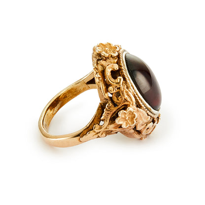 Exquisite Austro-Hungarian silver gilt ring with a beautiful cabochon garnet in an ornate floral setting. Circa 1900