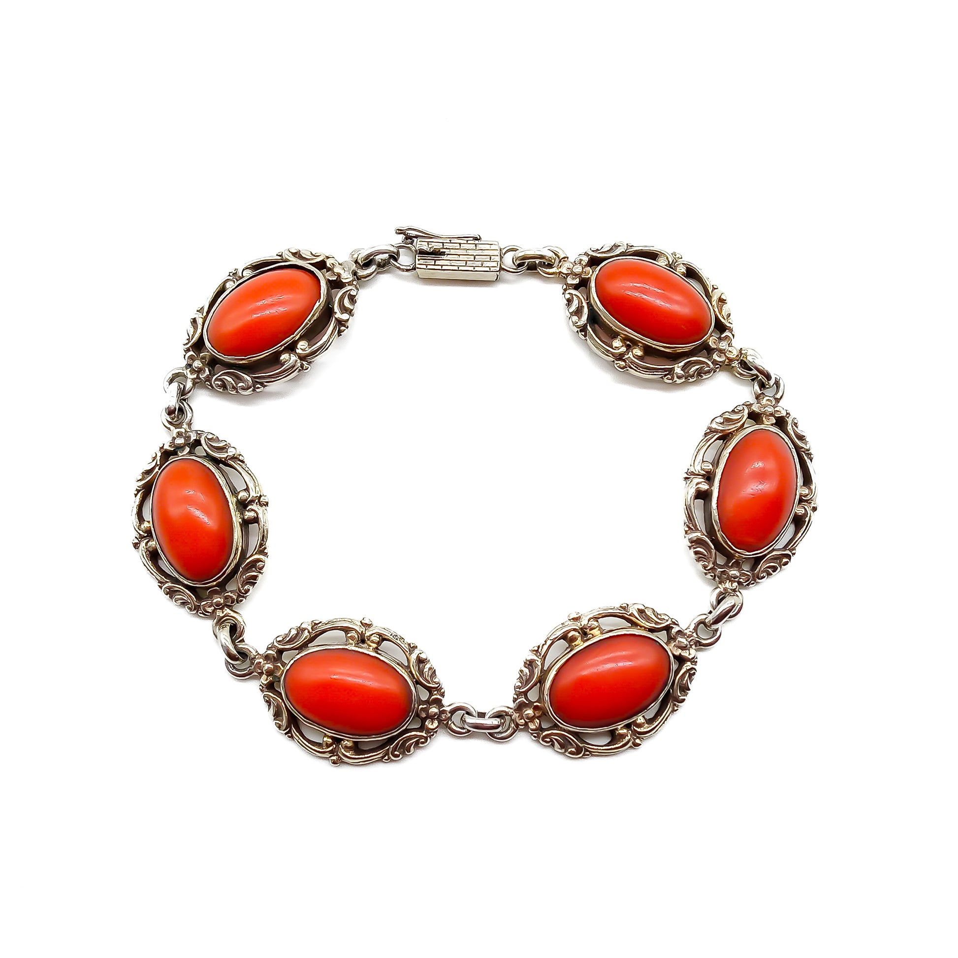 Ornate silver gilt bracelet set with six natural deep red Mediterranean coral cabochons. Safety clasp attached. Circa 1940’s