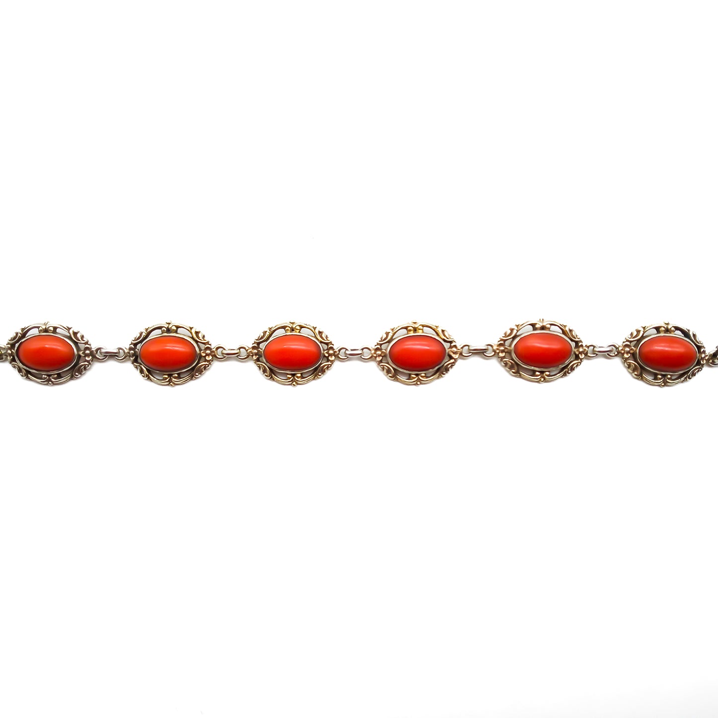 Ornate silver gilt bracelet set with six natural deep red Mediterranean coral cabochons. Safety clasp attached. Circa 1940’s