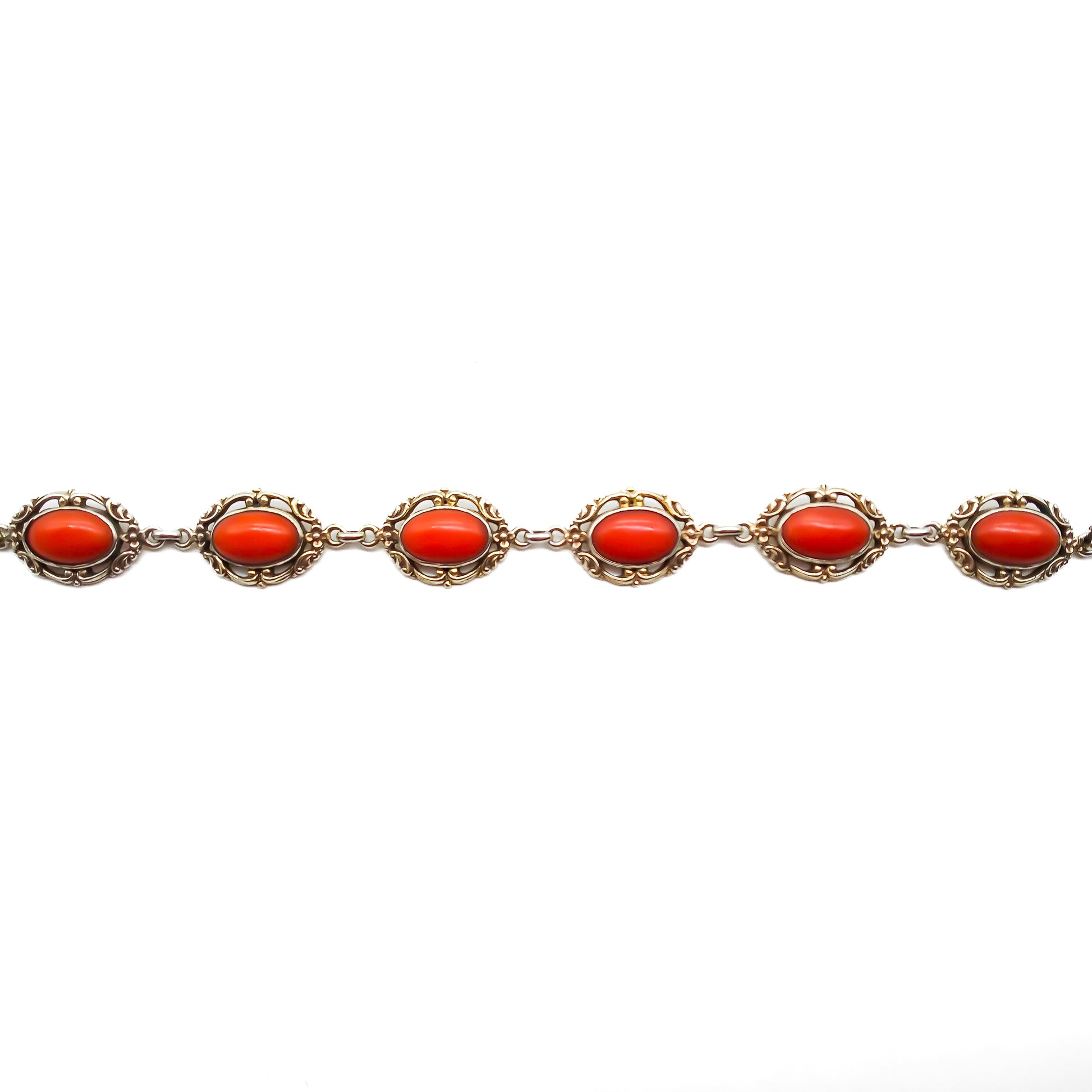 Ornate silver gilt bracelet set with six natural deep red Mediterranean coral cabochons. Safety clasp attached. Circa 1940’s