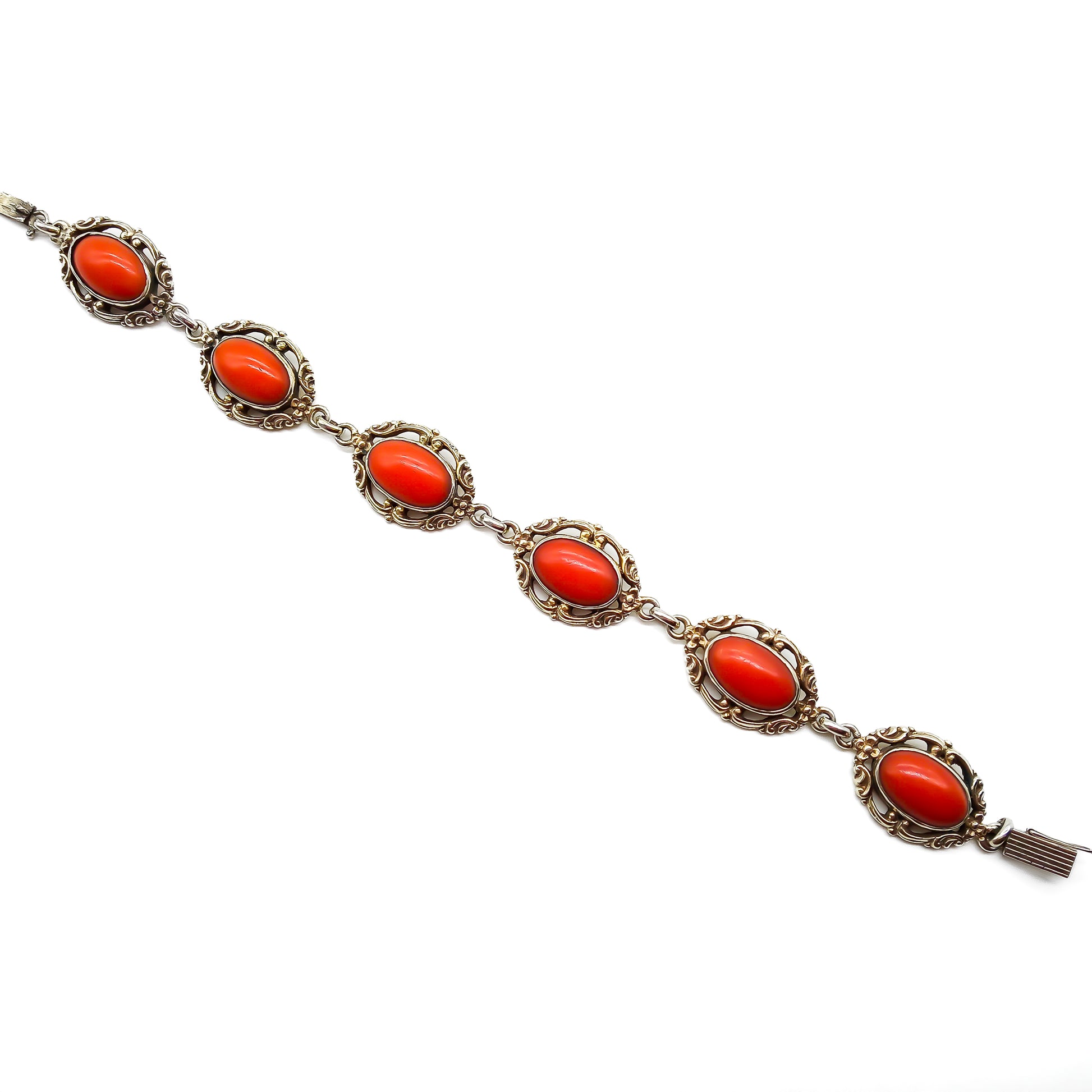 Ornate silver gilt bracelet set with six natural deep red Mediterranean coral cabochons. Safety clasp attached. Circa 1940’s