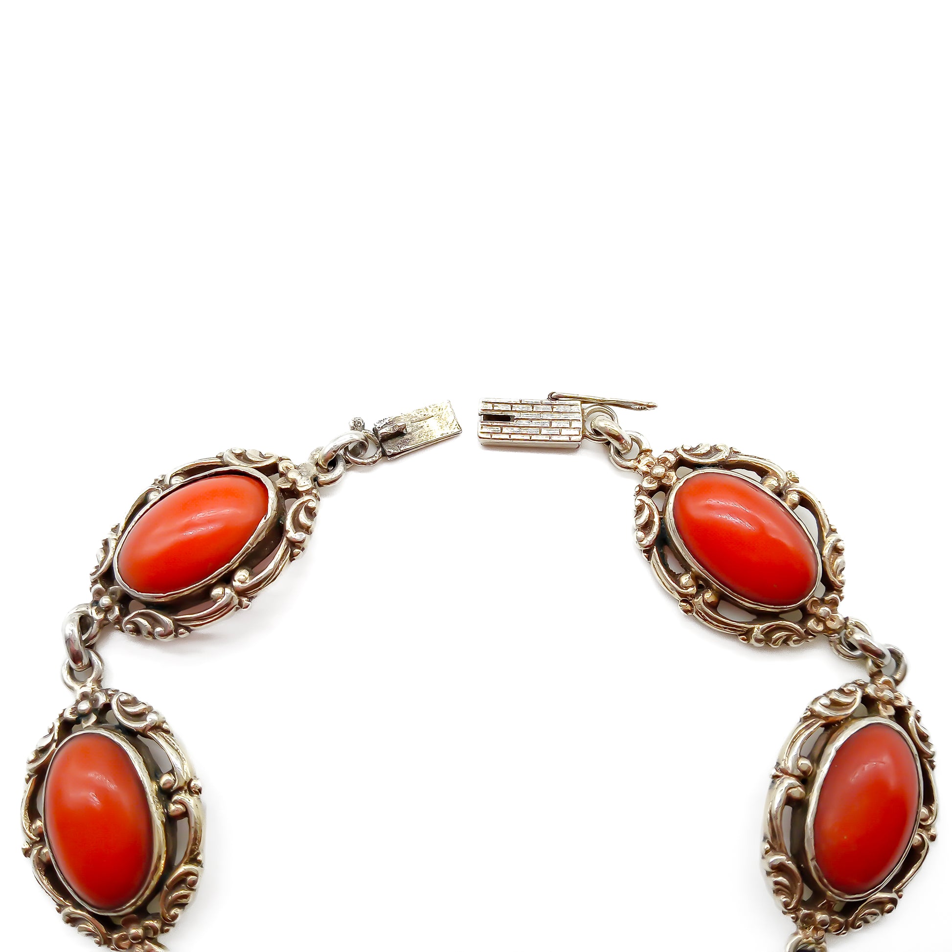 Ornate silver gilt bracelet set with six natural deep red Mediterranean coral cabochons. Safety clasp attached. Circa 1940’s