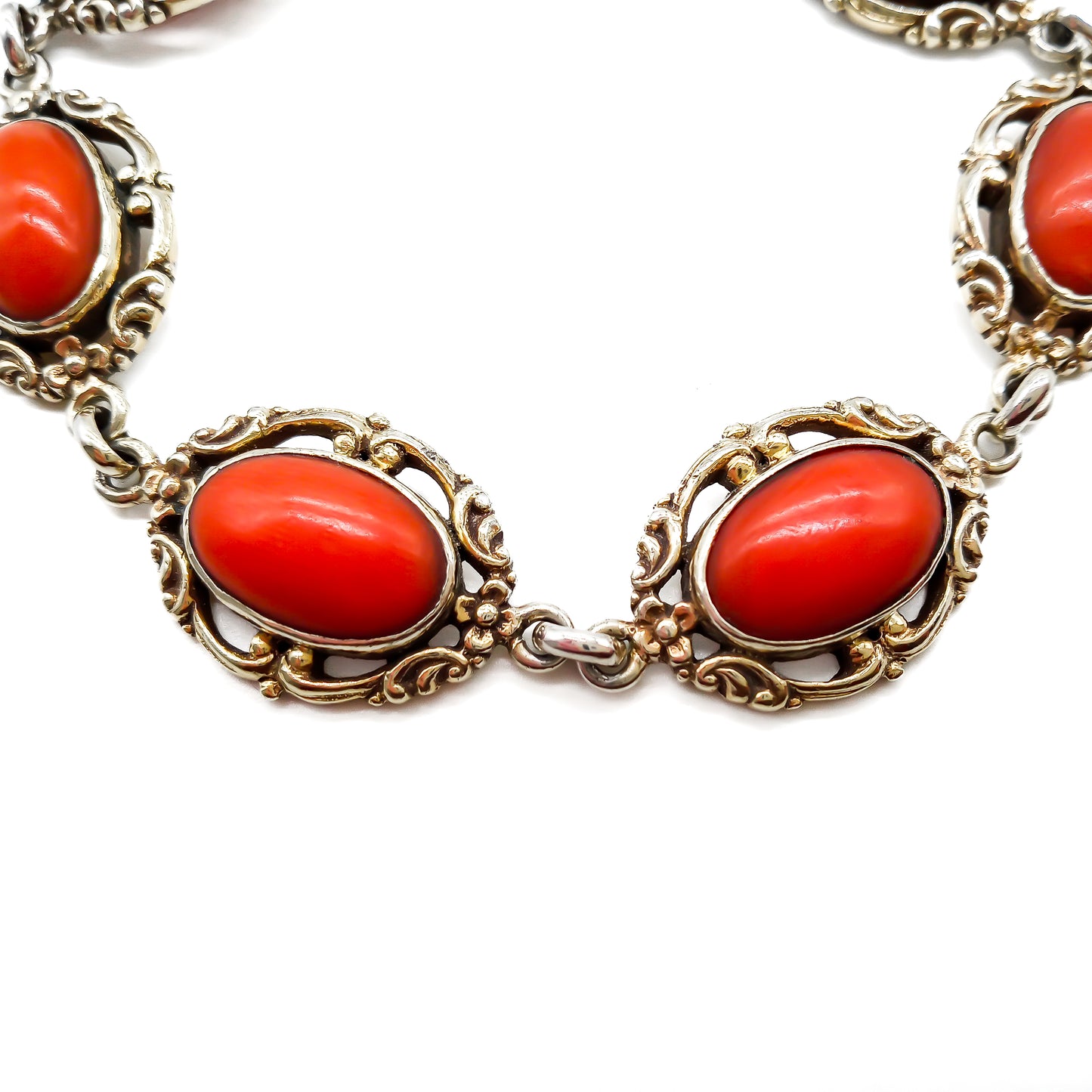 Ornate silver gilt bracelet set with six natural deep red Mediterranean coral cabochons. Safety clasp attached. Circa 1940’s