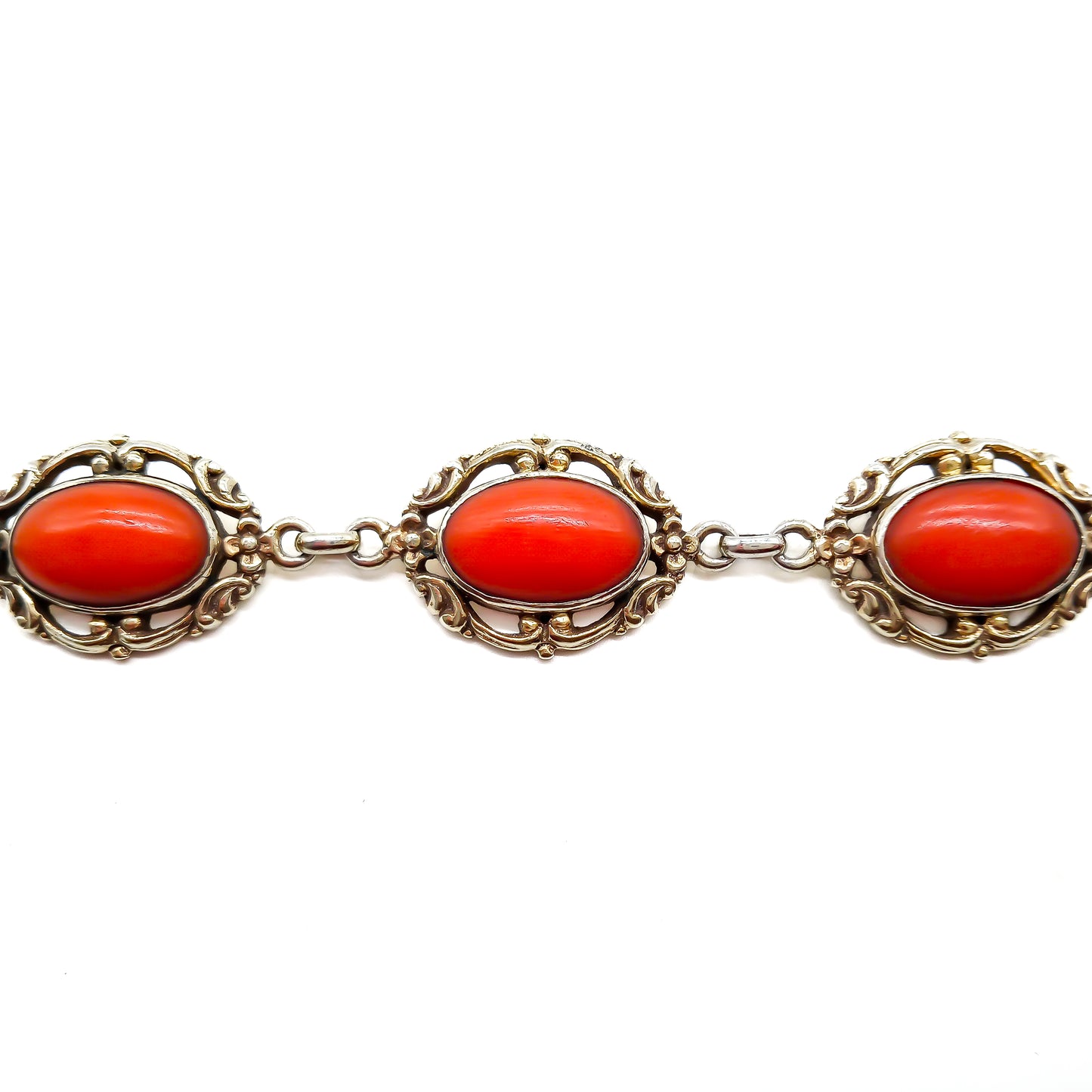 Ornate silver gilt bracelet set with six natural deep red Mediterranean coral cabochons. Safety clasp attached. Circa 1940’s