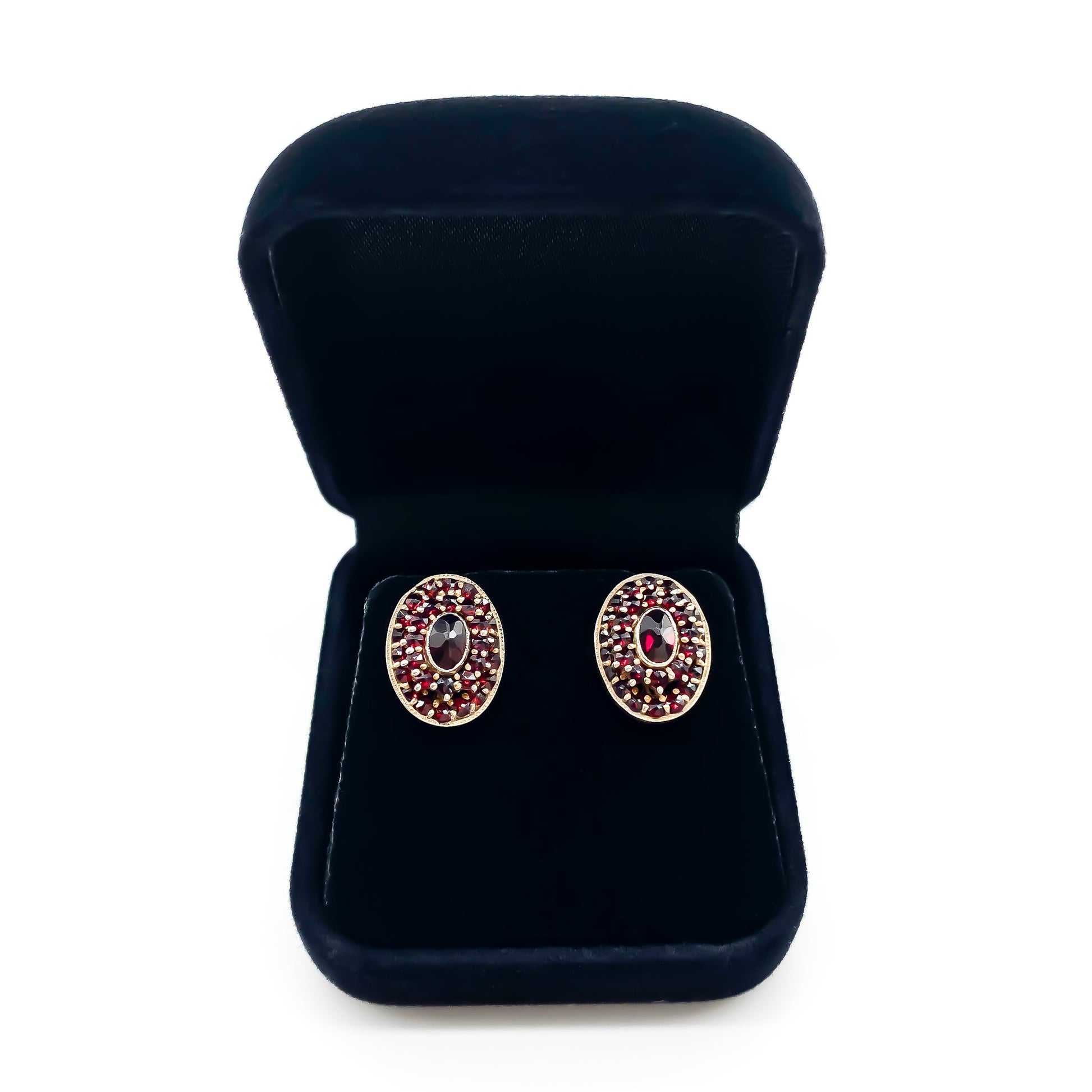 Lovely oval silver gilt stud earrings with garnets in a tier setting.