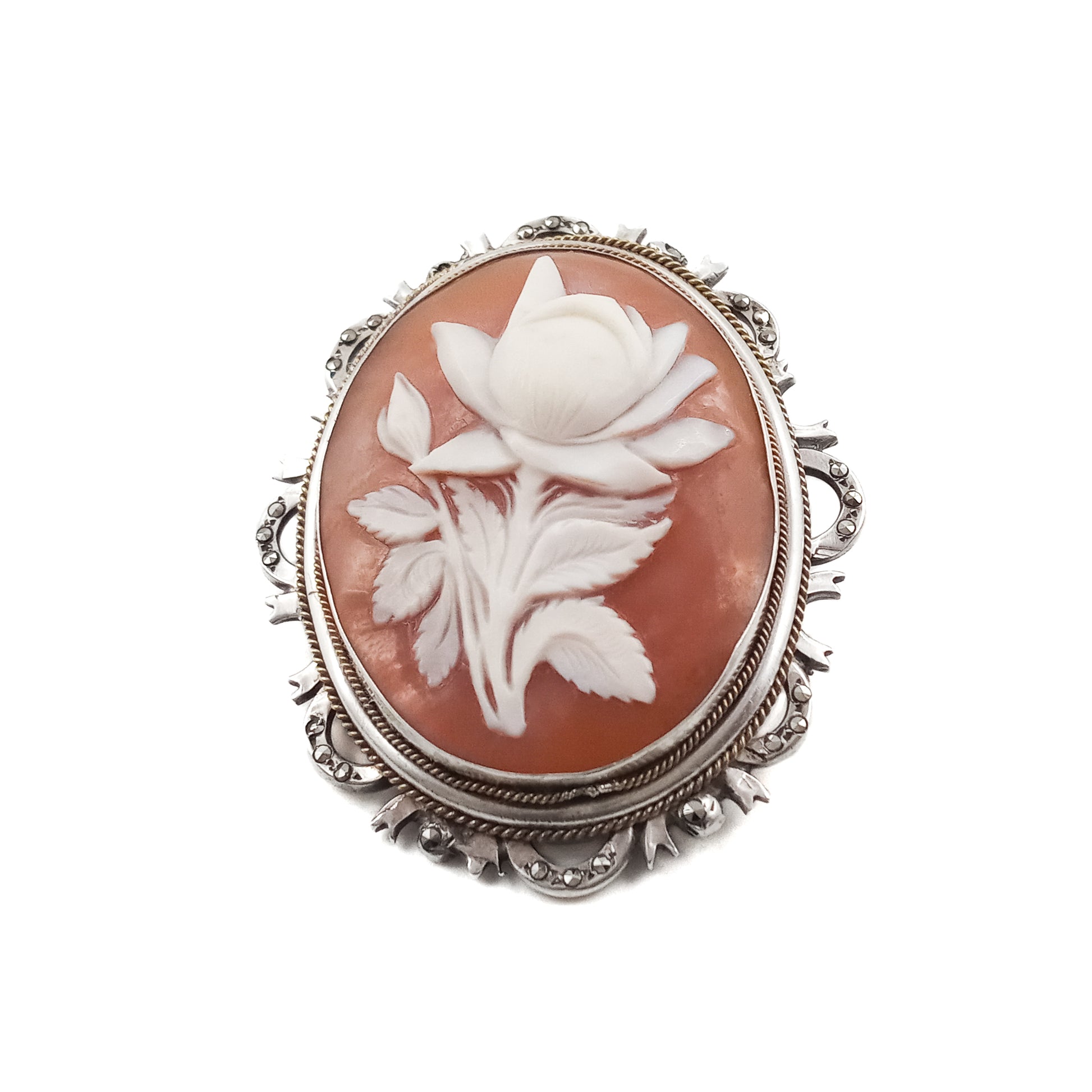 Unique silver brooch/pendant set with a beautifully carved rose cameo surrounded by marcasites. Circa 1930s