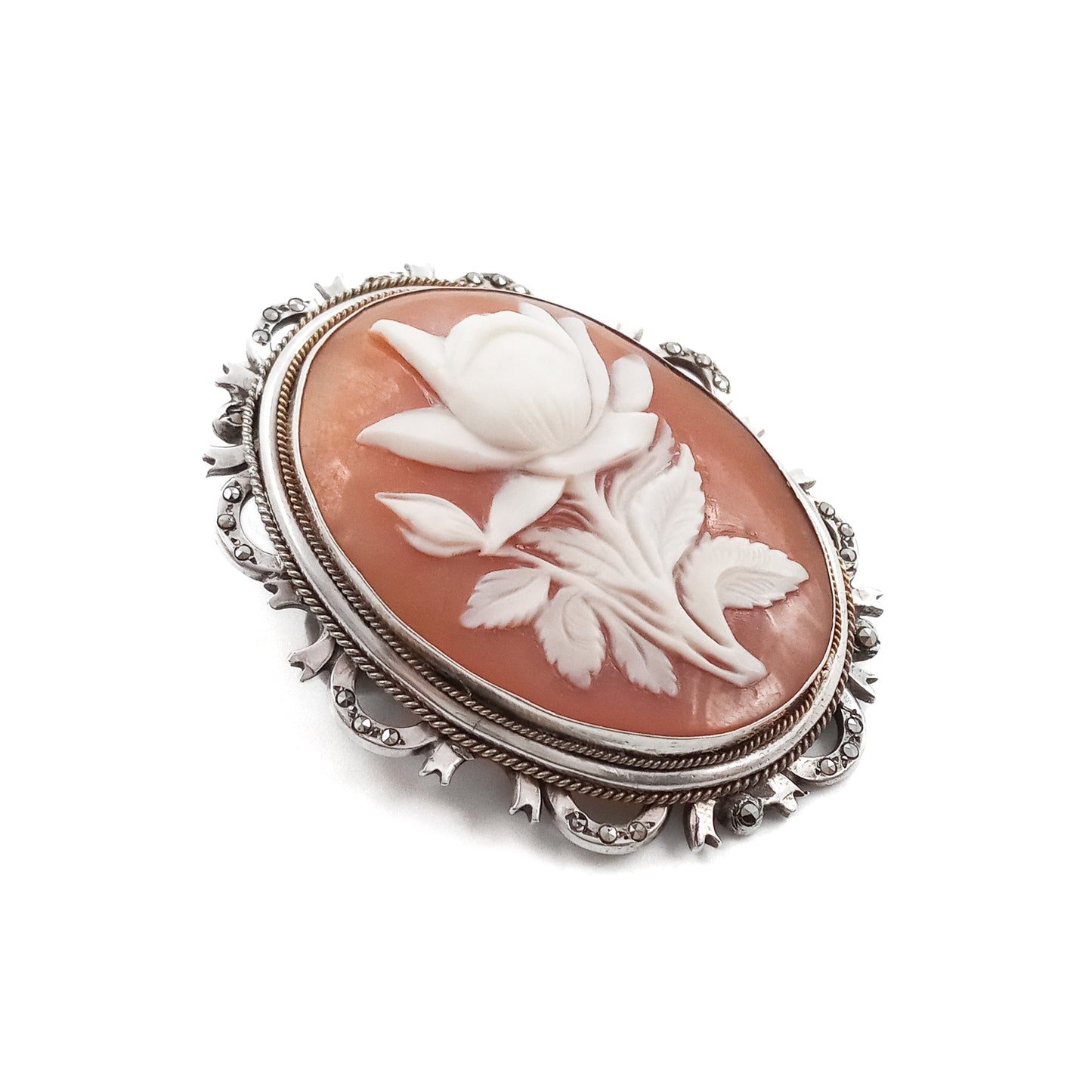 Unique silver brooch/pendant set with a beautifully carved rose cameo surrounded by marcasites. Circa 1930s