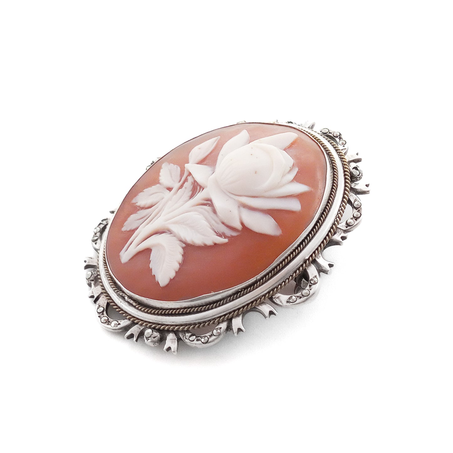 Unique silver brooch/pendant set with a beautifully carved rose cameo surrounded by marcasites. Circa 1930s