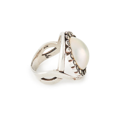 Glamorous vintage sterling silver ring set with a mabé pearl surrounded by nineteen marcasites.