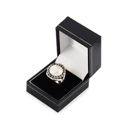 Glamorous vintage sterling silver ring set with a mabé pearl surrounded by nineteen marcasites.