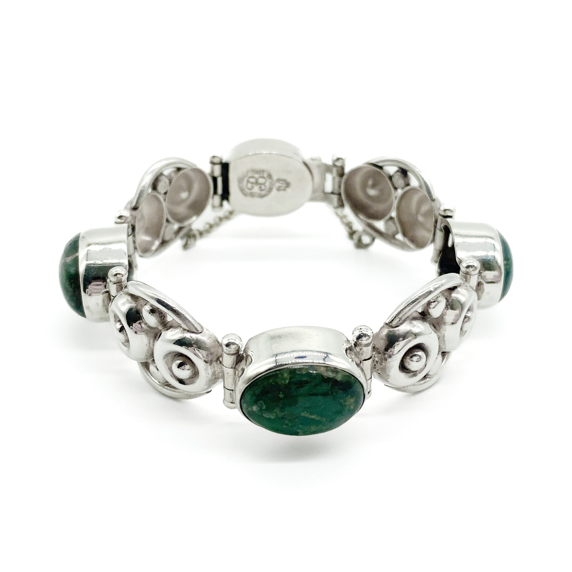 Stylish sterling silver Mexican articulated bracelet set with 3 natural green cabochon stones. Eagle mark - post 1947. Designer: Los Ballesteros