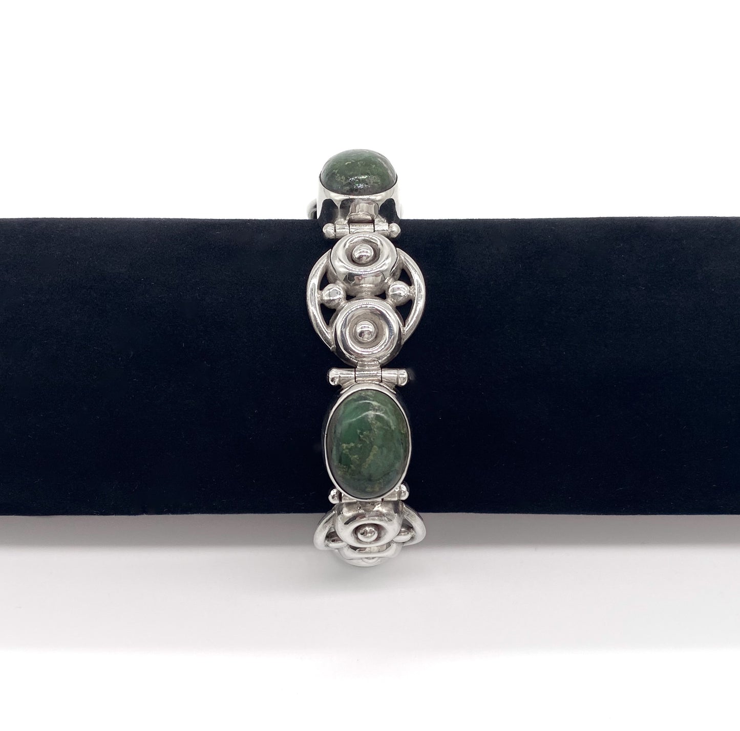 Stylish sterling silver Mexican articulated bracelet set with 3 natural green cabochon stones. Eagle mark - post 1947. Designer: Los Ballesteros