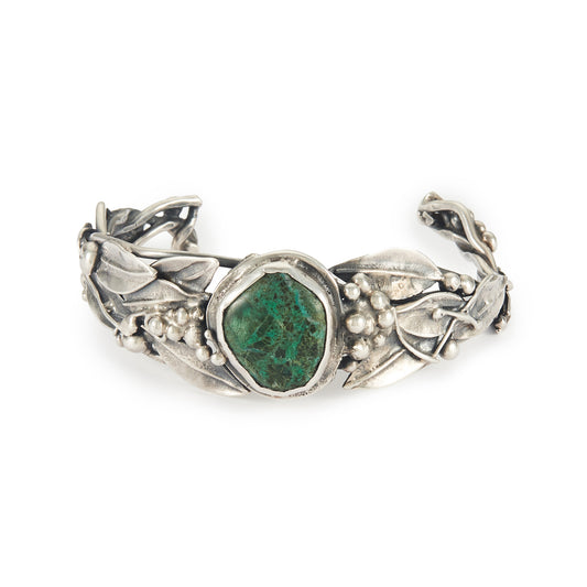 Stunning oxidised silver handmade bangle set with a dark green cabochon turquoise stone, surrounded by a leaf design. Ideal for a smaller wrist.