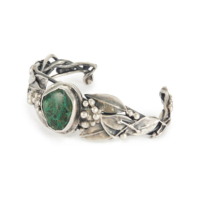 Stunning oxidised silver handmade bangle set with a dark green cabochon turquoise stone, surrounded by a leaf design. Ideal for a smaller wrist.