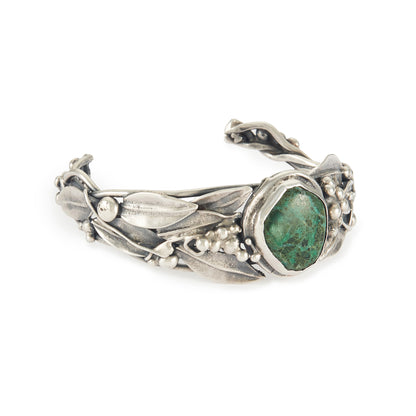 Stunning oxidised silver handmade bangle set with a dark green cabochon turquoise stone, surrounded by a leaf design. Ideal for a smaller wrist.