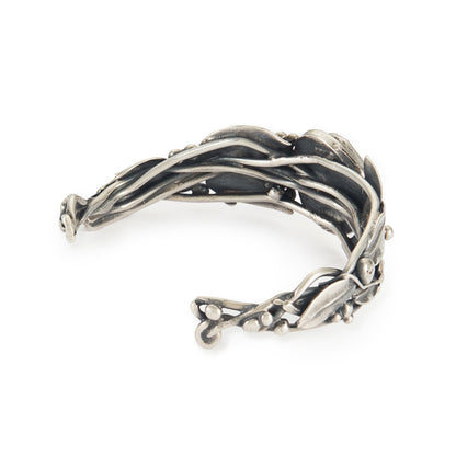 Stunning oxidised silver handmade bangle set with a dark green cabochon turquoise stone, surrounded by a leaf design. Ideal for a smaller wrist.