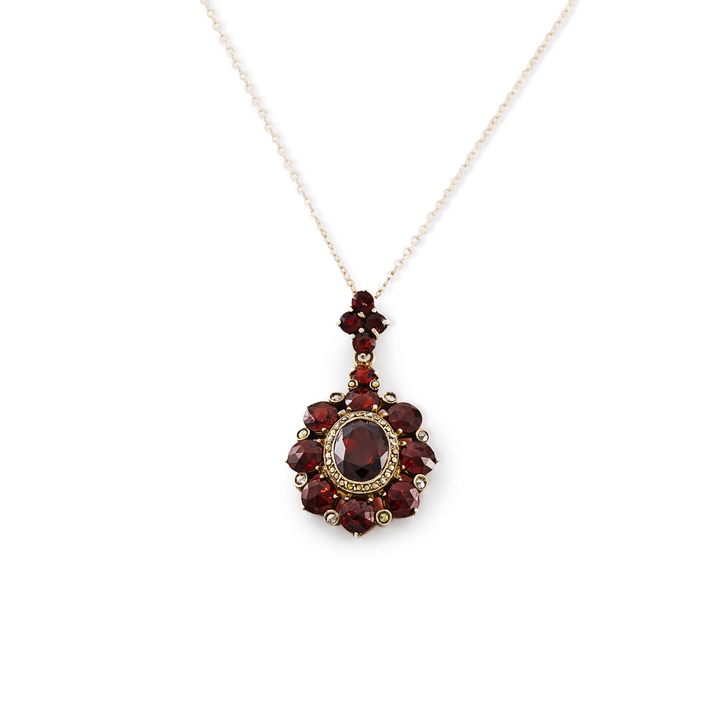 Exquisite silver gilt pendant on a silver chain, set with thirteen deep red old cut garnets and a larger oval garnet surrounded by marcasites in the centre.