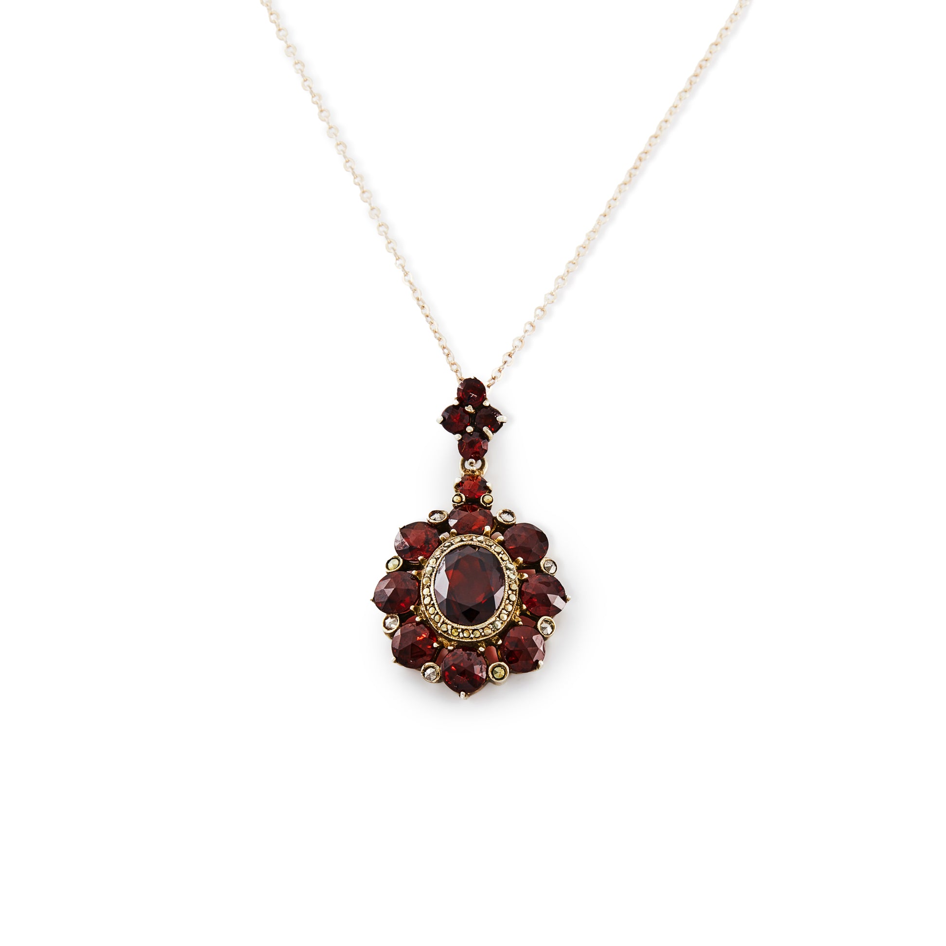 Exquisite silver gilt pendant on a silver chain, set with thirteen deep red old cut garnets and a larger oval garnet surrounded by marcasites in the centre.