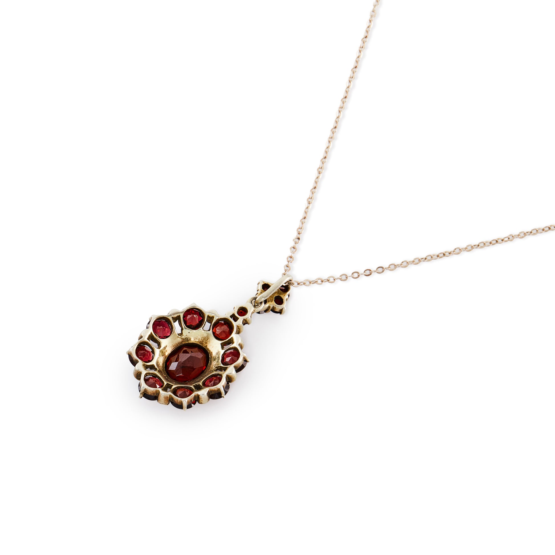 Exquisite silver gilt pendant on a silver chain, set with thirteen deep red old cut garnets and a larger oval garnet surrounded by marcasites in the centre.