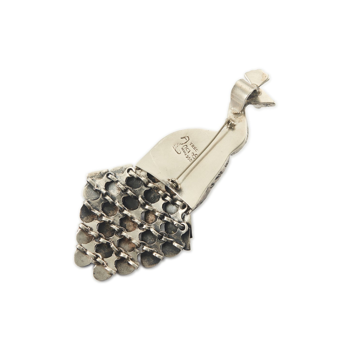 Magnificent Mexican oxidised high grade silver peacock pendant/brooch with twenty-three cabochon turquoise stones set in its articulated tail feathers, with a garnet eye. 