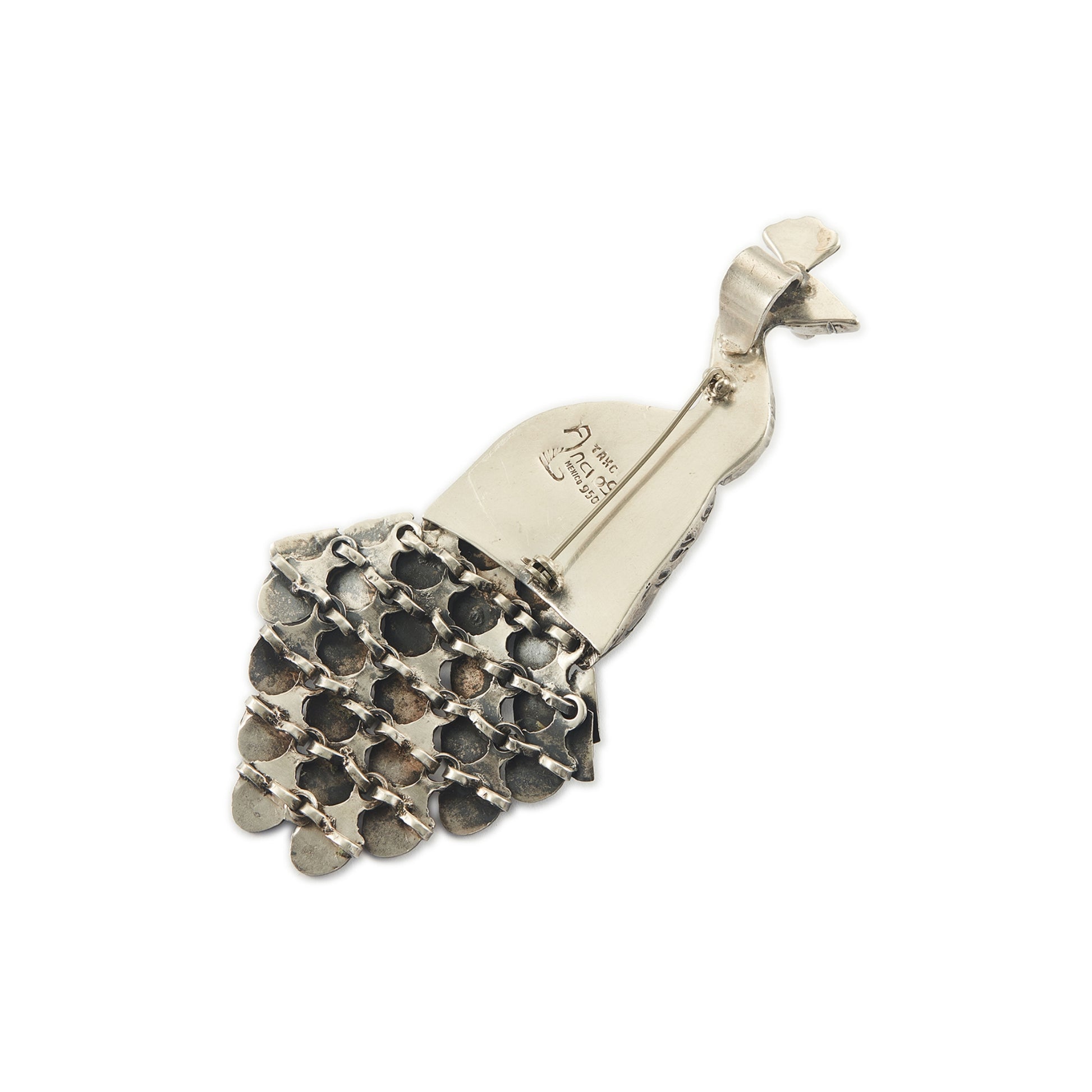 Magnificent Mexican oxidised high grade silver peacock pendant/brooch with twenty-three cabochon turquoise stones set in its articulated tail feathers, with a garnet eye. 