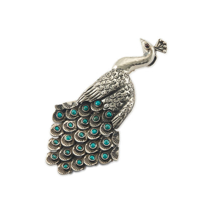Magnificent Mexican oxidised high grade silver peacock pendant/brooch with twenty-three cabochon turquoise stones set in its articulated tail feathers, with a garnet eye. 