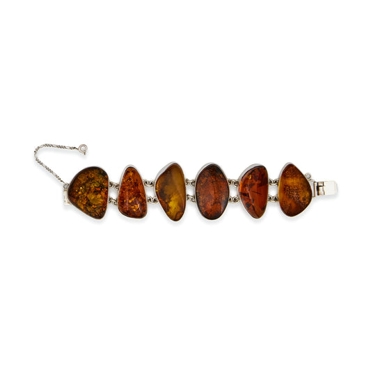 Stunning sterling silver belcher link bracelet, set with six beautiful organic shaped natural pieces of amber in a variety of different hues. Safety chain attached.